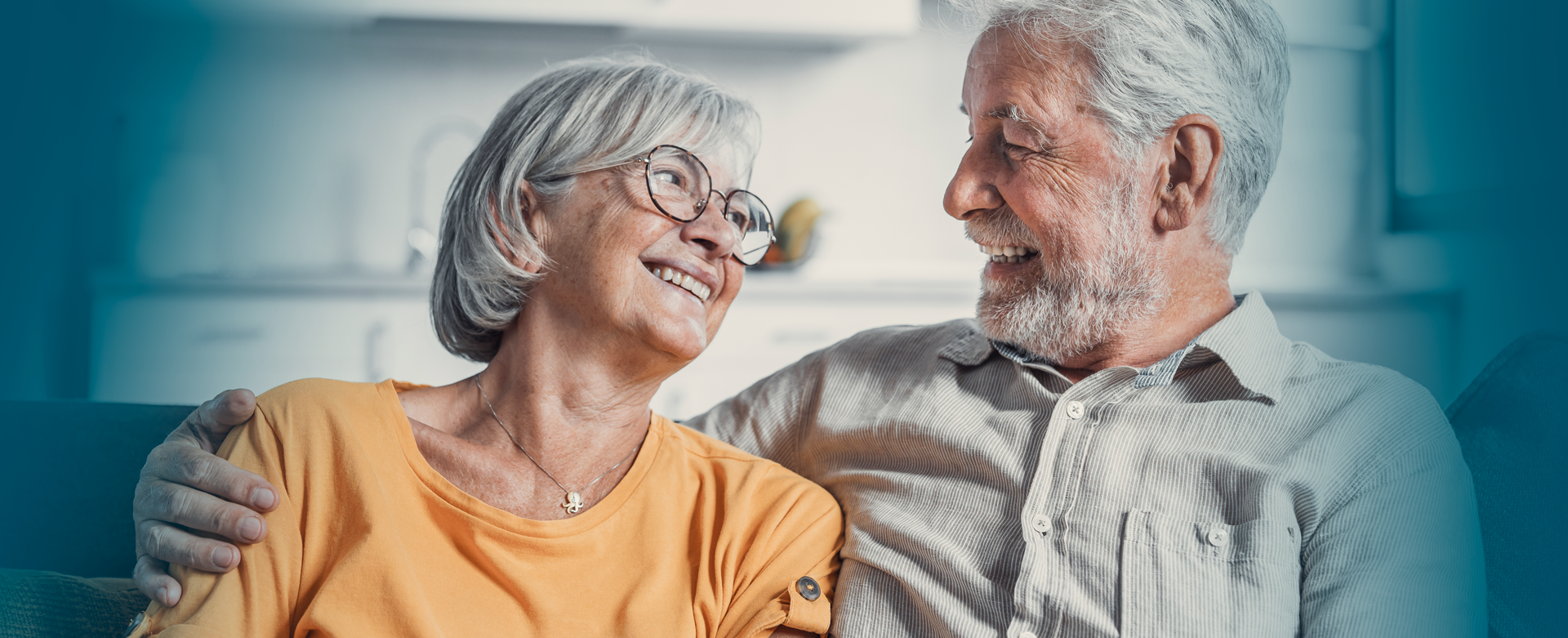 Happy senior couple embracing at home